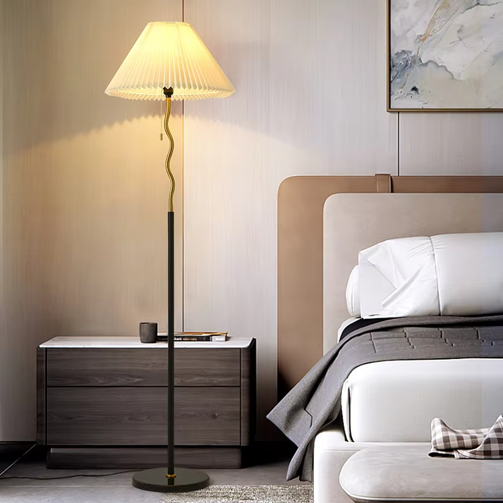 This is a modern minimalist black spherical decorative floor lamp, with a black metal pole featuring spherical decorative elements and a beige pleated fabric lampshade. It has a minimalist and textured design, with soft and warm lighting. It is used for space lighting and decoration, creating a warm and comfortable atmosphere. Suitable for modern minimalist living rooms, bedroom corners, Nordic-style homes and other places.