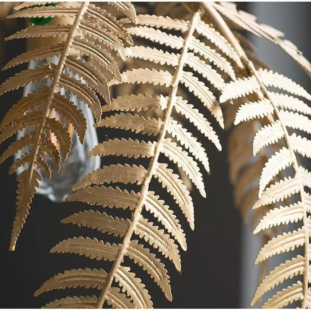 This is a tropical artistic floor lamp with golden palm leaf-shaped lamp heads and a metal pole, featuring a strong tropical artistic sense. It is used for space lighting and decoration, creating a tropical artistic atmosphere. It is suitable for tropical-style home living rooms, creative cafes, art homestays and other places.