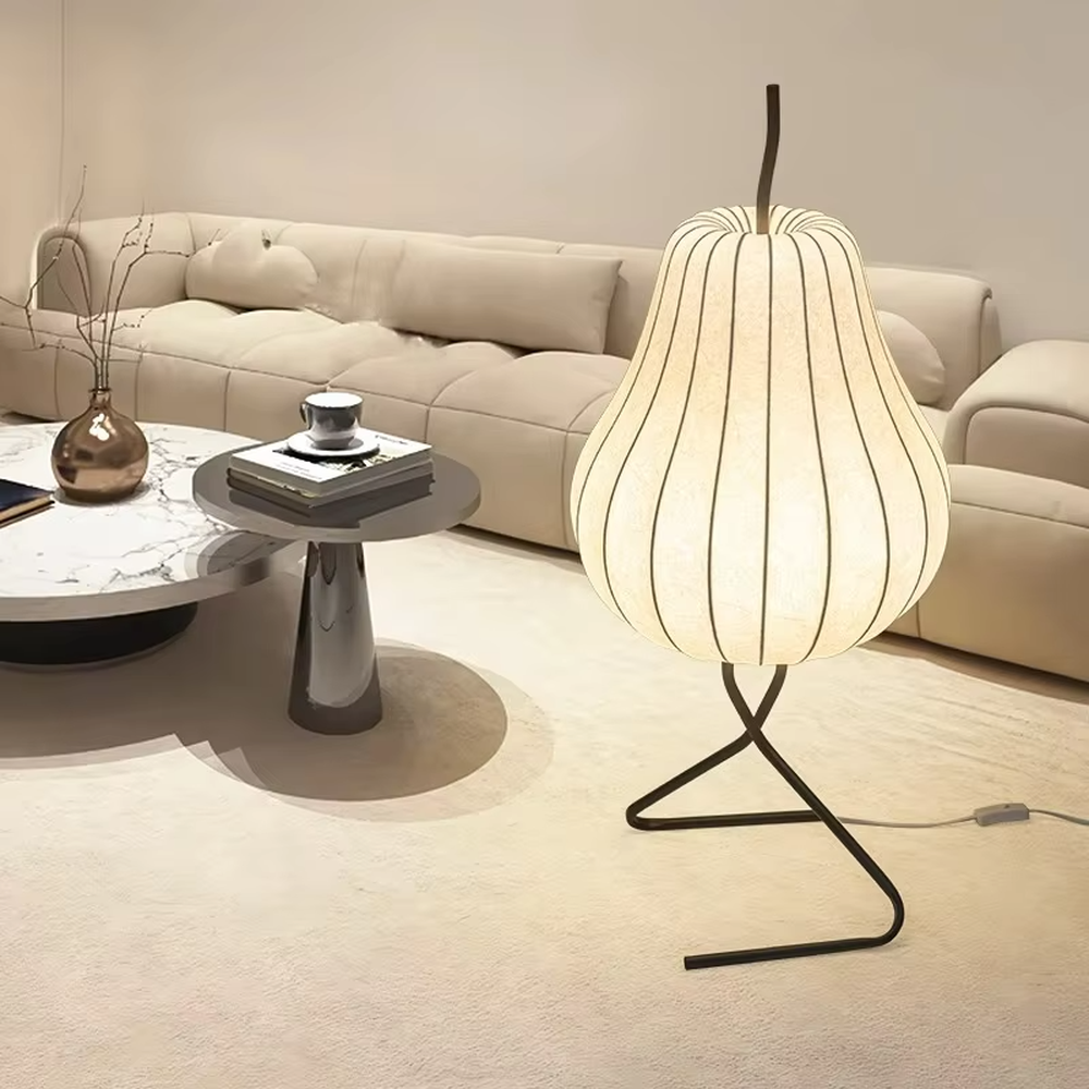 This is a childlike artistic pear-shaped floor lamp, made of paper-like material to create a pear shape, paired with a black metal stand. It features a childlike and natural design, with warm and soft lighting. It is used for space ambient lighting and decoration, creating a childlike and natural atmosphere. Suitable for Nordic-style homes, literary homestays, children's rooms and other places.