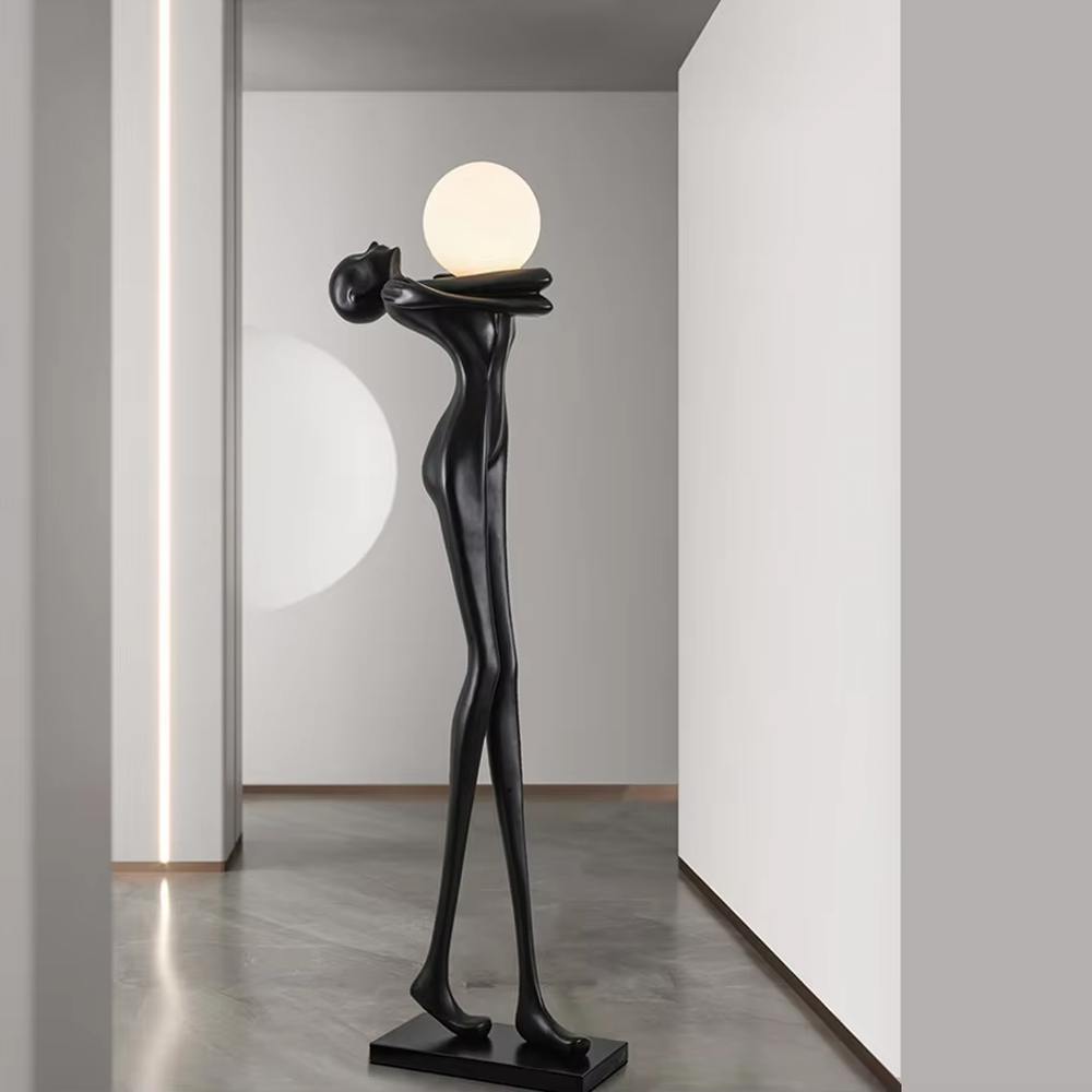 This is an artistic human-shaped floor lamp, featuring a black human sculpture holding a circular luminous lamp, with a white marble base. It has a strong artistic sense and modern luxury style. It is used for space lighting and decoration, creating an artistic atmosphere. It is suitable for modern art home living rooms, high-end hotel lobbies, art exhibition halls and other places.