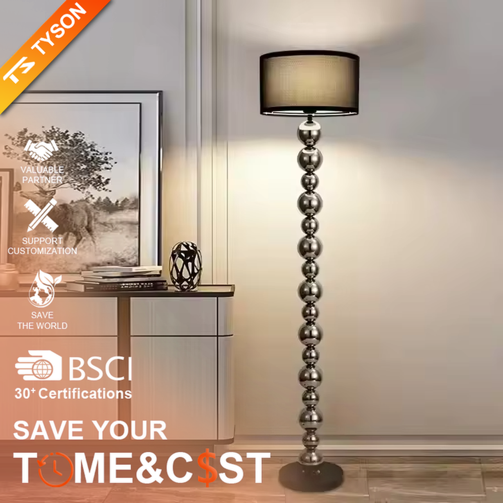 This is a modern light luxury-style silver spherical decorative floor lamp, with a silver metal pole composed of multiple spherical elements connected in series, paired with a beige fabric lampshade. It features a minimalist and textured design, with soft and warm lighting. It is used for space lighting and decoration, creating a light luxury and warm atmosphere. Suitable for modern light luxury living rooms, bedroom corners, high-end apartments and other places.
