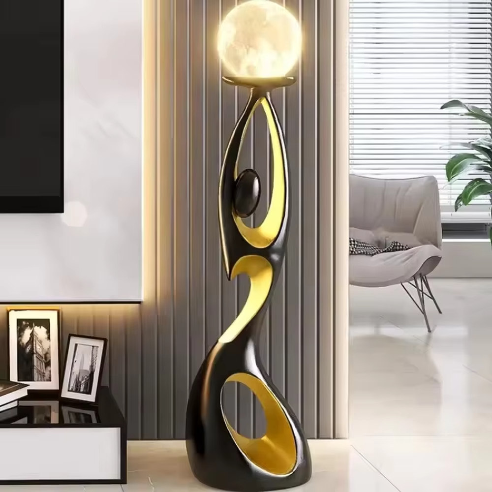 This is an artistic human-shaped black-gold floor lamp, featuring a black-gold artistic human sculpture holding a moon-shaped luminous lamp, with strong artistic sense and modern luxury style. It is used for space lighting and decoration, creating an artistic atmosphere. It is suitable for modern art home living rooms, high-end hotel lobbies, art exhibition halls and other places.