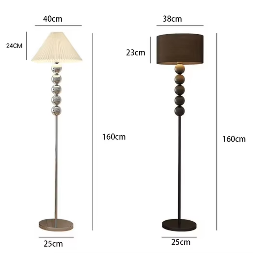 This is a modern warm-style black spherical decorative floor lamp, with a black metal pole featuring spherical decorative elements and a brown fabric lampshade. It has a minimalist and textured design, with soft lighting. It is used for space lighting and decoration, creating a warm and comfortable atmosphere. Suitable for modern minimalist bedrooms, living room corners, Nordic-style homes and other places.