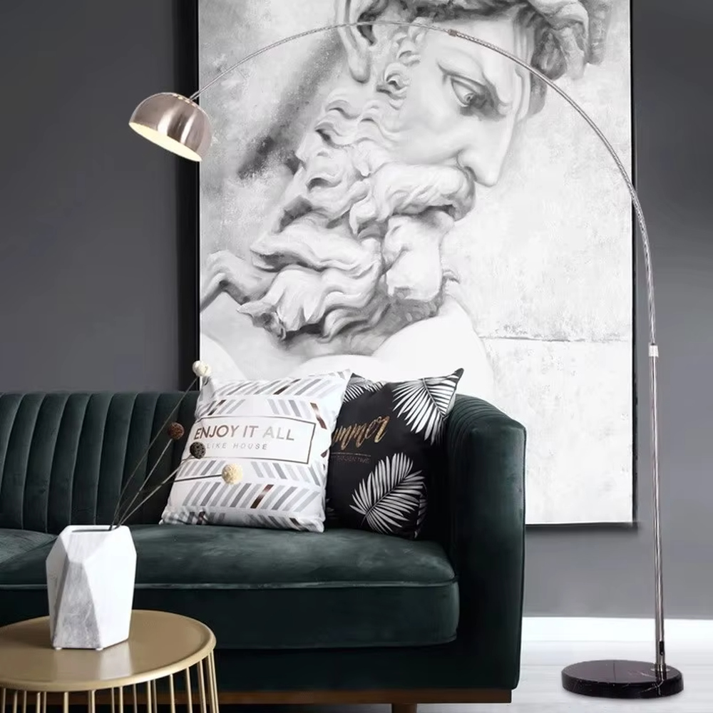 This is a modern luxury arc floor lamp with a golden curved lamp pole, a black marble base, and a golden dome lampshade. It features a simple and elegant design, combining artistry and practicality. It is used for space lighting and decoration, creating a luxurious and fashionable ambiance. It is suitable for modern home living rooms, luxury apartment living areas, high-end hotel leisure spaces and other places.