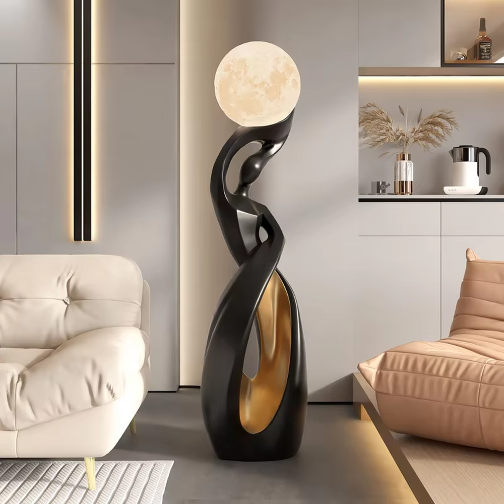 This is an artistic human-shaped black-gold floor lamp, featuring a black-gold artistic human sculpture holding a moon-shaped luminous lamp, with strong artistic sense and modern luxury style. It is used for space lighting and decoration, creating an artistic atmosphere. It is suitable for modern art home living rooms, high-end hotel lobbies, art exhibition halls and other places.