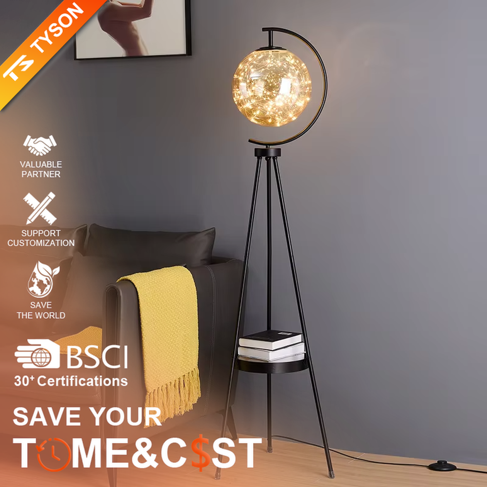 This is a light luxury modern-style golden tripod glass ball floor lamp, with a golden tripod structure, a transparent glass ball (with built-in light string) and a small tray, featuring an exquisite light luxury design, warm lighting. It is used for space lighting and decoration, creating a light luxury and warm atmosphere. Suitable for modern light luxury living rooms, bedroom corners, Nordic-style homes and other places.