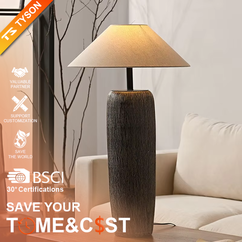 This is a natural wabi-sabi style gray textured column floor lamp, with a gray textured column base, a beige fabric conical lampshade, and a black metal pole connection. It features a minimalist and natural design with a rustic texture. It is used for space lighting and decoration, creating a warm and rustic atmosphere. Suitable for wabi-sabi style living rooms, Japanese-style bedrooms, natural-style homestays and other places.