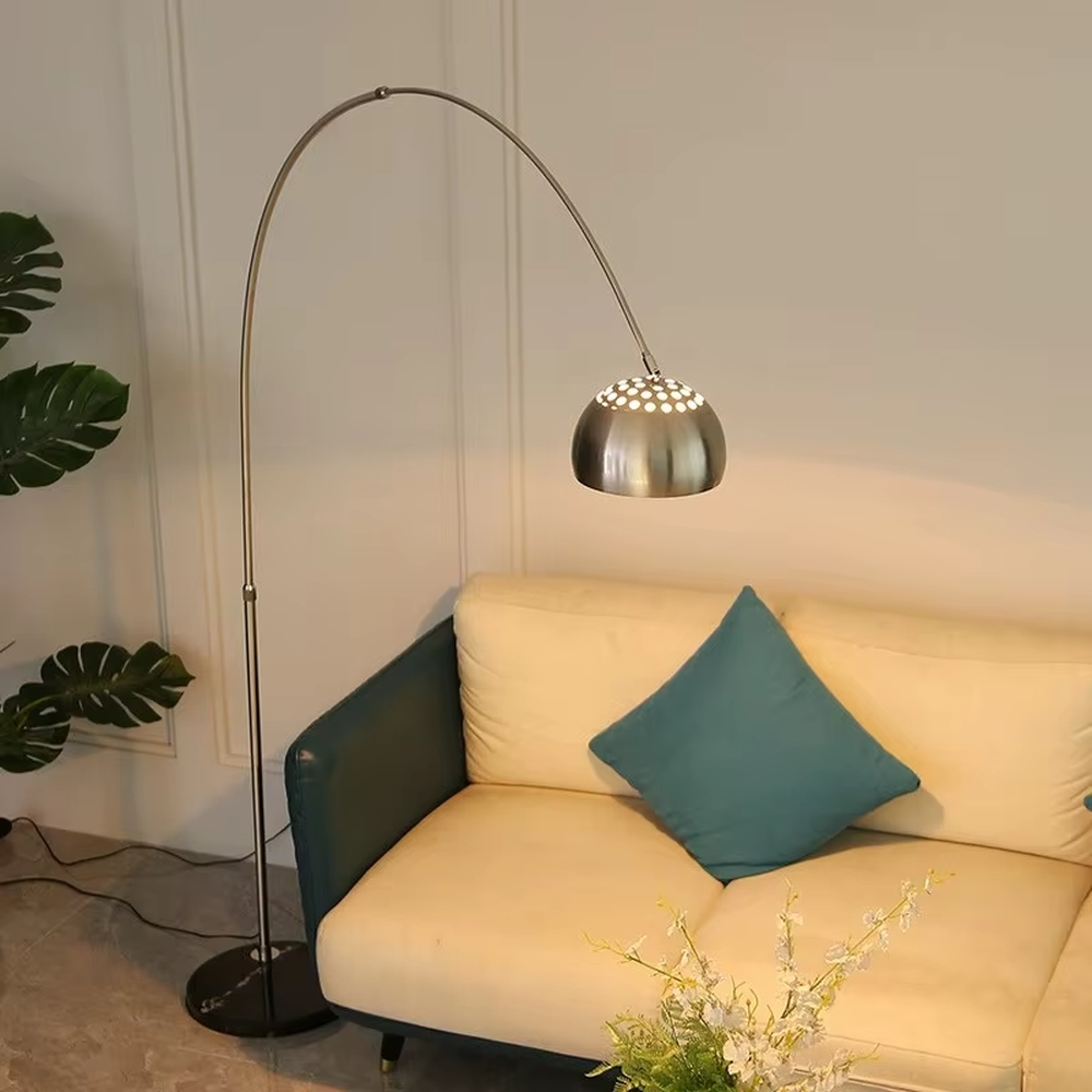 This is a modern luxury arc floor lamp with a golden curved lamp pole, a black marble base, and a golden dome lampshade. It features a simple and elegant design, combining artistry and practicality. It is used for space lighting and decoration, creating a luxurious and fashionable ambiance. It is suitable for modern home living rooms, luxury apartment living areas, high-end hotel leisure spaces and other places.