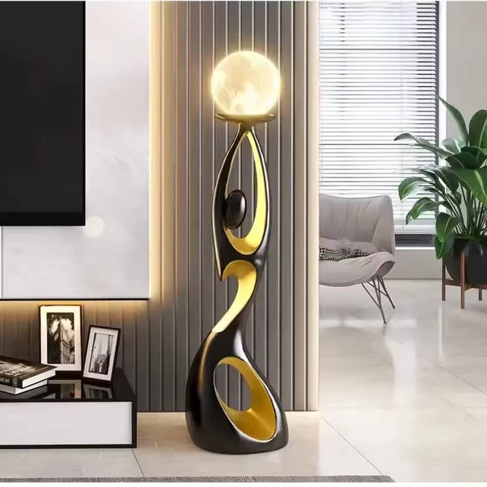 This is an artistic human-shaped black-gold floor lamp, featuring a black-gold artistic human sculpture holding a moon-shaped luminous lamp, with strong artistic sense and modern luxury style. It is used for space lighting and decoration, creating an artistic atmosphere. It is suitable for modern art home living rooms, high-end hotel lobbies, art exhibition halls and other places.