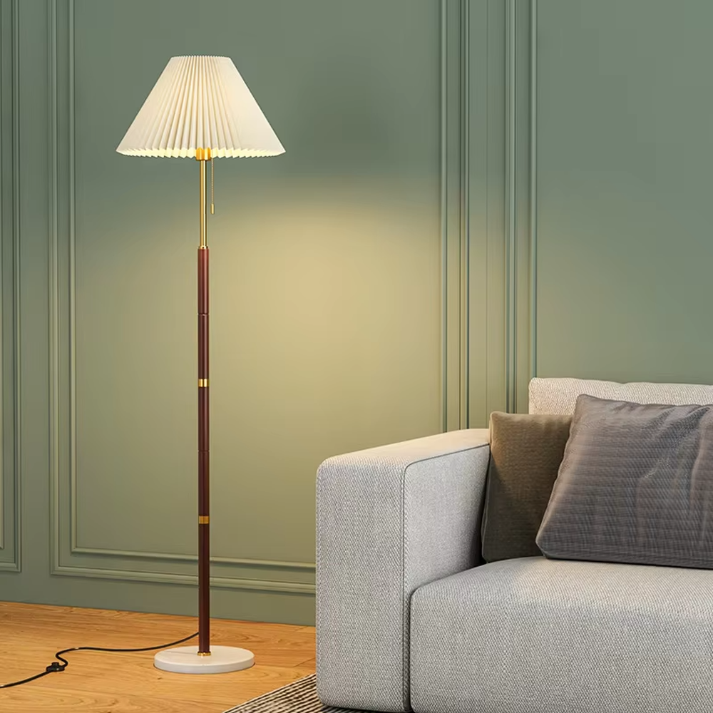 Light luxury vintage-style dark brown lamp pole gray pleated floor lamp, paired with golden decorations and base, soft and warm lighting, creating a high-end elegant space atmosphere.