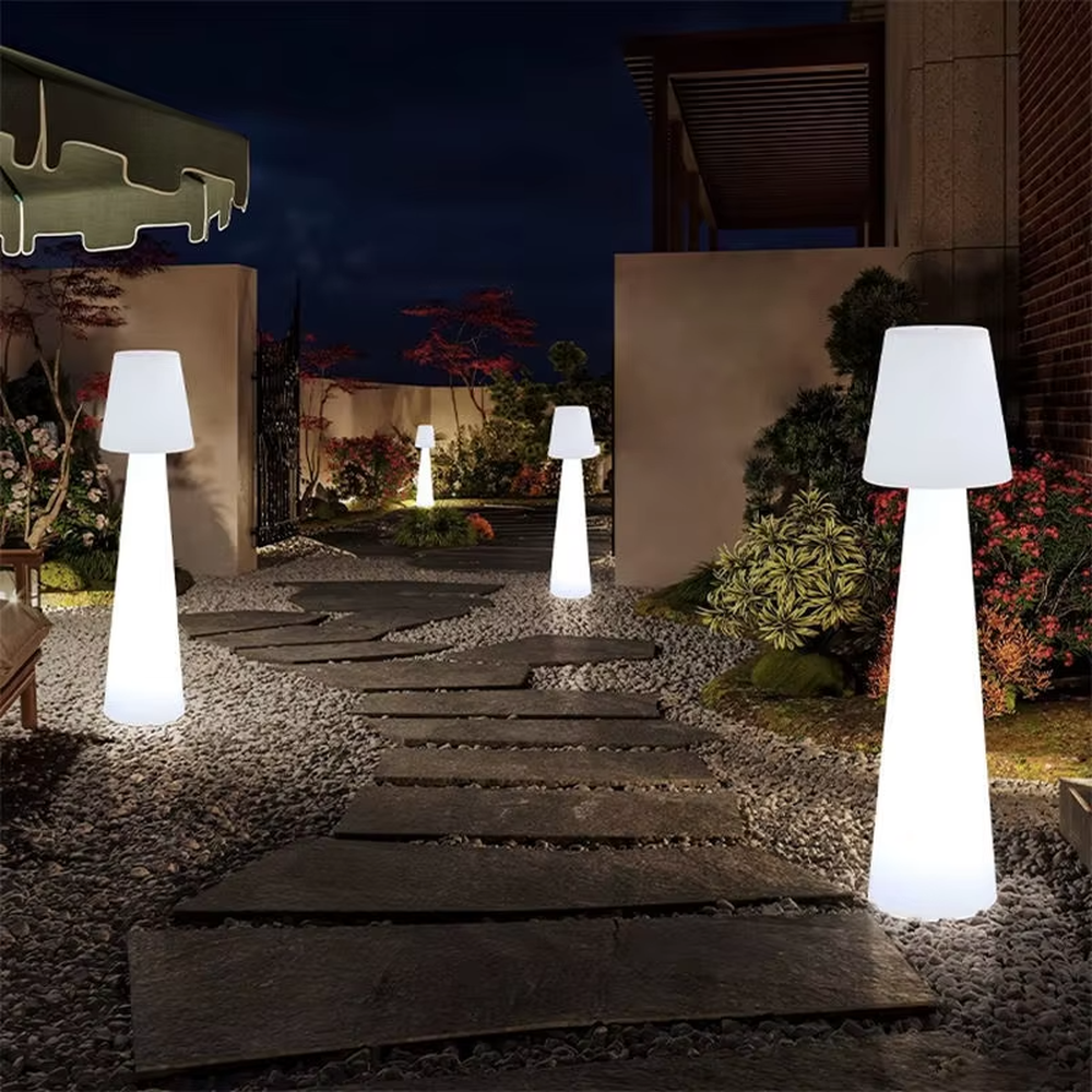 This is an outdoor warm-style conical luminous floor lamp, featuring an integrated conical cylinder + small conical lampshade shape, waterproof material suitable for outdoor environments, soft warm light, creating a comfortable and warm outdoor atmosphere.