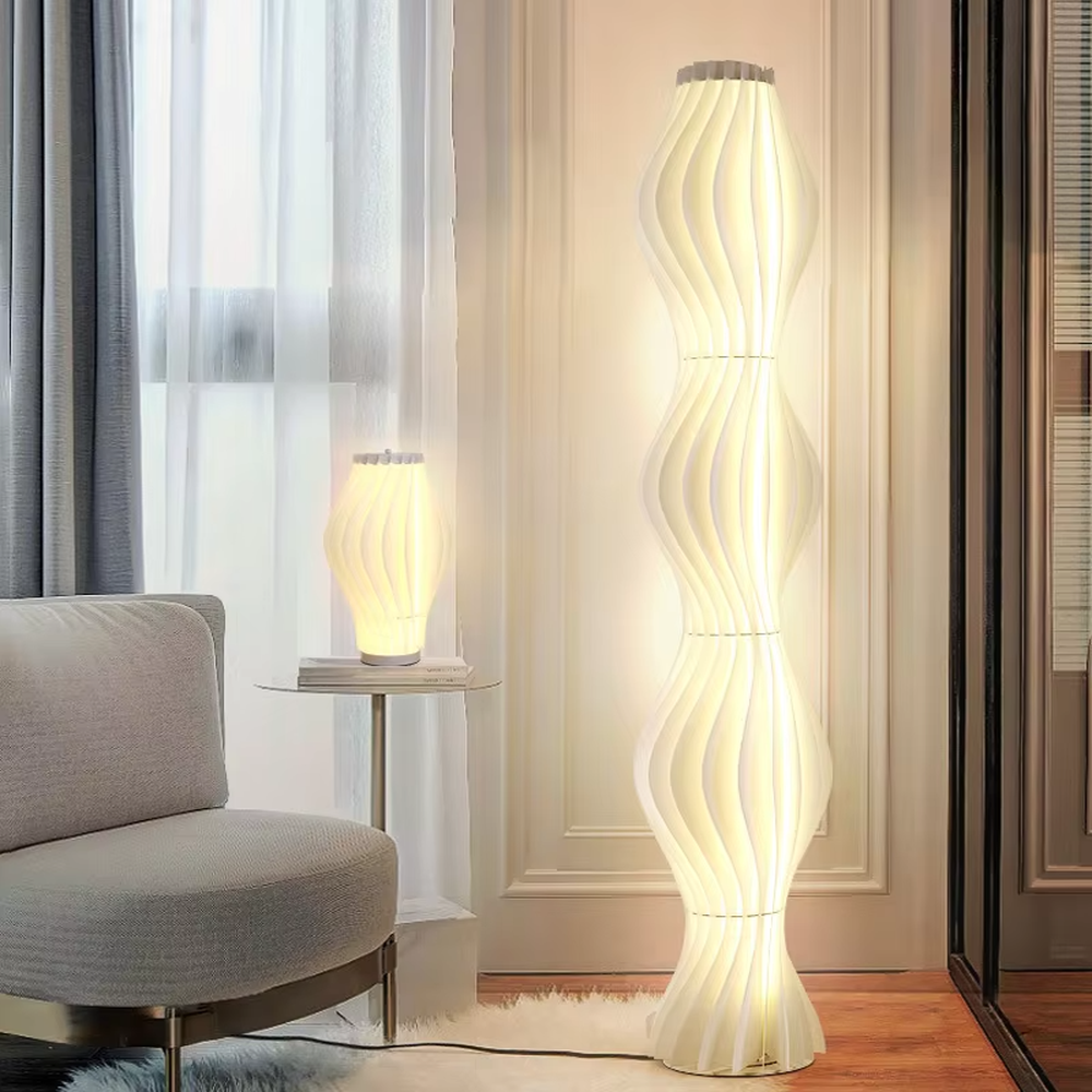 This is a modern artistic wave-patterned floor lamp, made of striped pleated material to create a multi-layer wave shape. The light-colored appearance is simple and flexible, and the light through the material is soft and hazy. It is used for space lighting and decoration to create a modern artistic atmosphere. Suitable for modern-style living rooms, art exhibition halls, high-end homestays and other places.