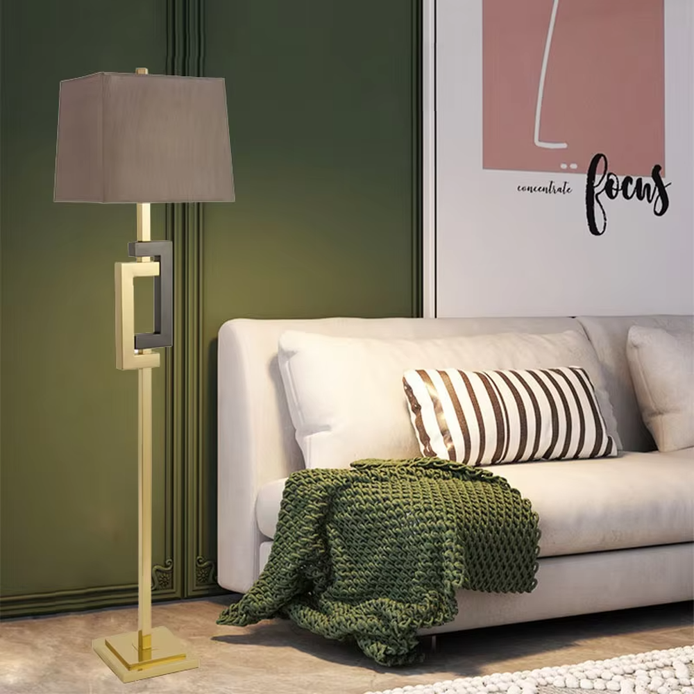 Light luxury black-gold geometric decorative floor lamp, golden metal lamp pole + dark brown square fabric lampshade, soft lighting, creating a high-end elegant atmosphere.