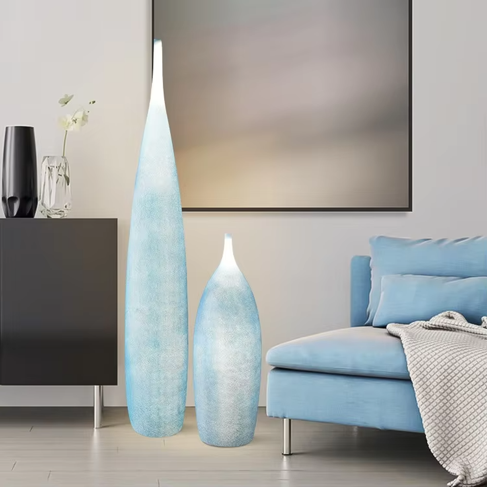 This is a Zen minimalist bottle-shaped paper art floor lamp (including large and small styles), made of light beige paper art texture material to create a slender bottle shape, with a large and small combination design. The light through the material is soft and hazy, creating a quiet and elegant atmosphere. It is used for space lighting and decoration, suitable for Zen-style spaces, minimalist homes and other places.