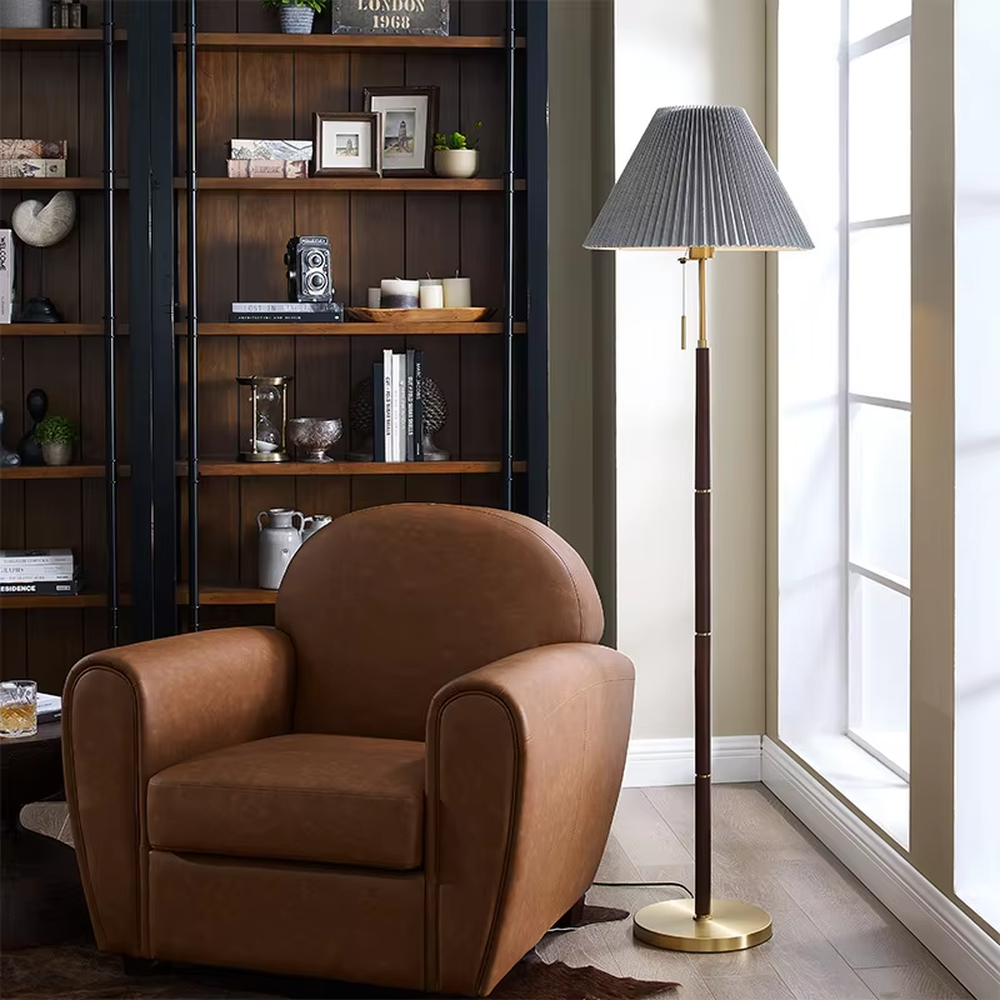 Light luxury vintage-style dark brown lamp pole gray pleated floor lamp, paired with golden decorations and base, soft and warm lighting, creating a high-end elegant space atmosphere.
