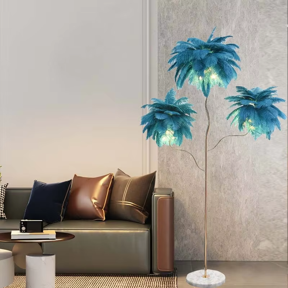 This is a light luxury soft feather-shaped floor lamp, equipped with three white feather lampshades, paired with a golden curved lamp pole and a marble base. The design is gentle and elegant, with soft and hazy lighting through the feathers. It is used for space lighting and decoration, creating a warm and soft light luxury atmosphere. Suitable for light luxury-style living rooms, bedrooms, internet-famous homestays and other places.