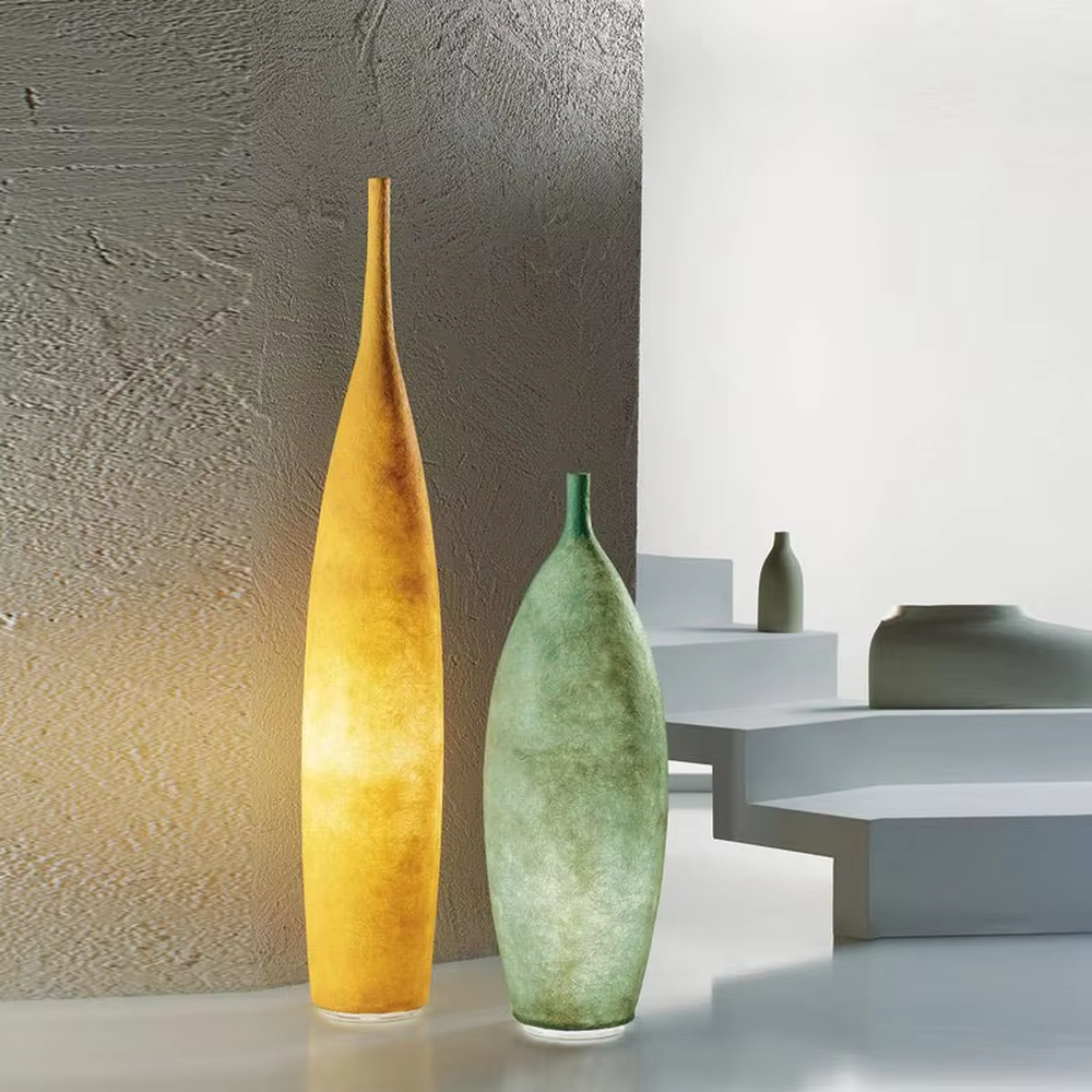 This is a Zen minimalist bottle-shaped paper art floor lamp (including large and small styles), made of light beige paper art texture material to create a slender bottle shape, with a large and small combination design. The light through the material is soft and hazy, creating a quiet and elegant atmosphere. It is used for space lighting and decoration, suitable for Zen-style spaces, minimalist homes and other places.