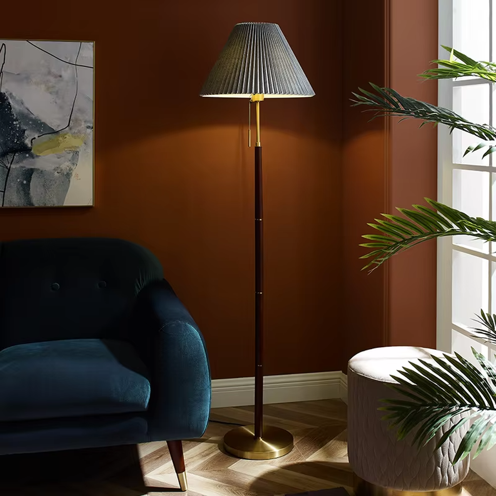 Light luxury vintage-style dark brown lamp pole gray pleated floor lamp, paired with golden decorations and base, soft and warm lighting, creating a high-end elegant space atmosphere.