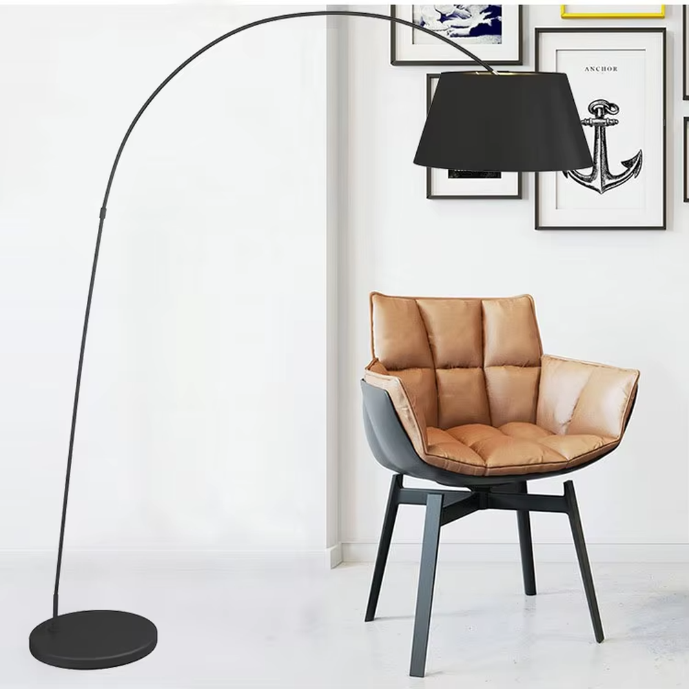 Modern minimalist curved floor lamp, black curved lamp pole paired with a black-outside-gold-inside hemisphere lampshade and a black disc base, soft and warm lighting, creating a minimalist high-end space atmosphere.
