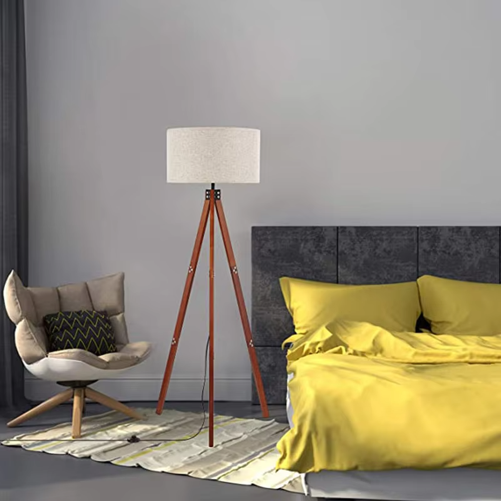 Vintage natural-style reddish-brown wooden tripod floor lamp, paired with beige fabric lampshade, soft and warm lighting, creating a natural and comfortable space atmosphere.