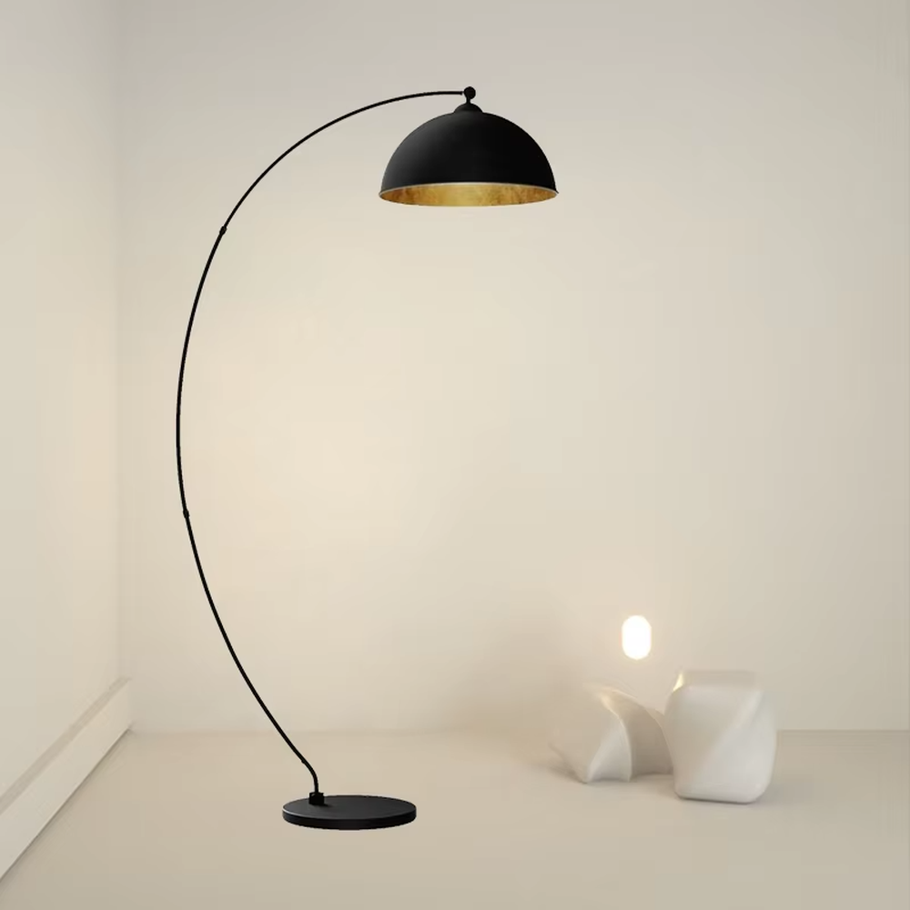 This is a modern minimalist light luxury curved floor lamp, with a black curved lamp pole paired with a black-outside-gold-inside hemisphere lampshade, and a black disc base. The lighting is soft and warm, creating a minimalist high-end atmosphere.