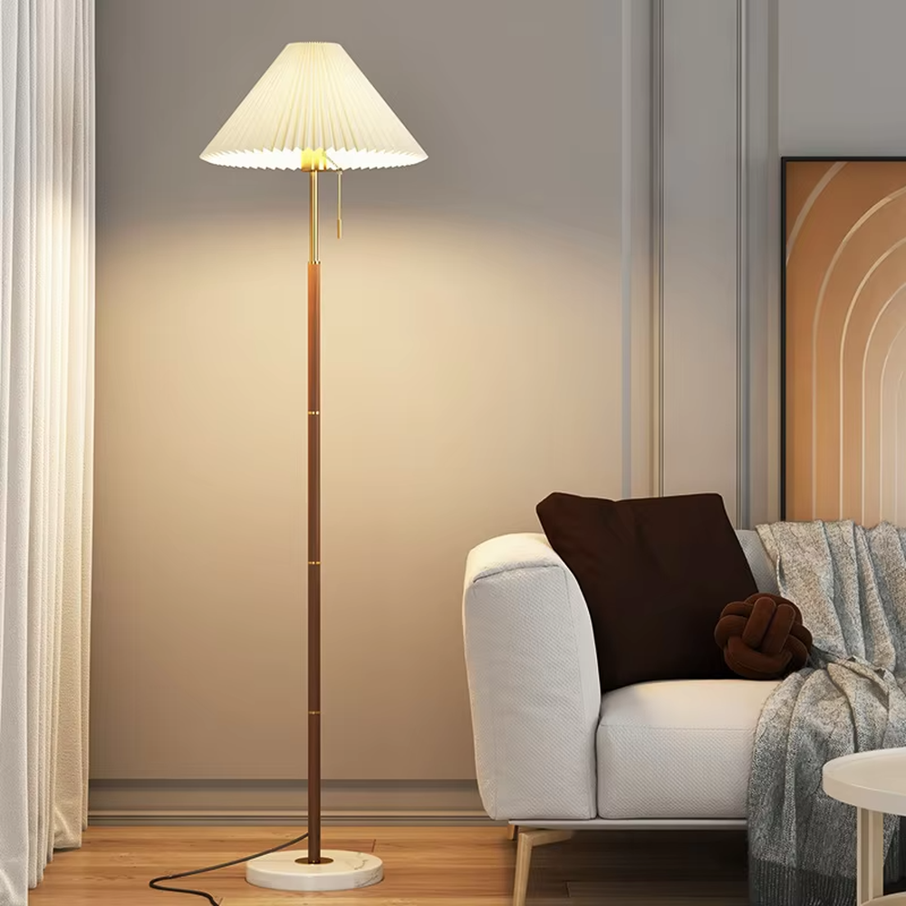 Light luxury vintage-style dark brown lamp pole gray pleated floor lamp, paired with golden decorations and base, soft and warm lighting, creating a high-end elegant space atmosphere.
