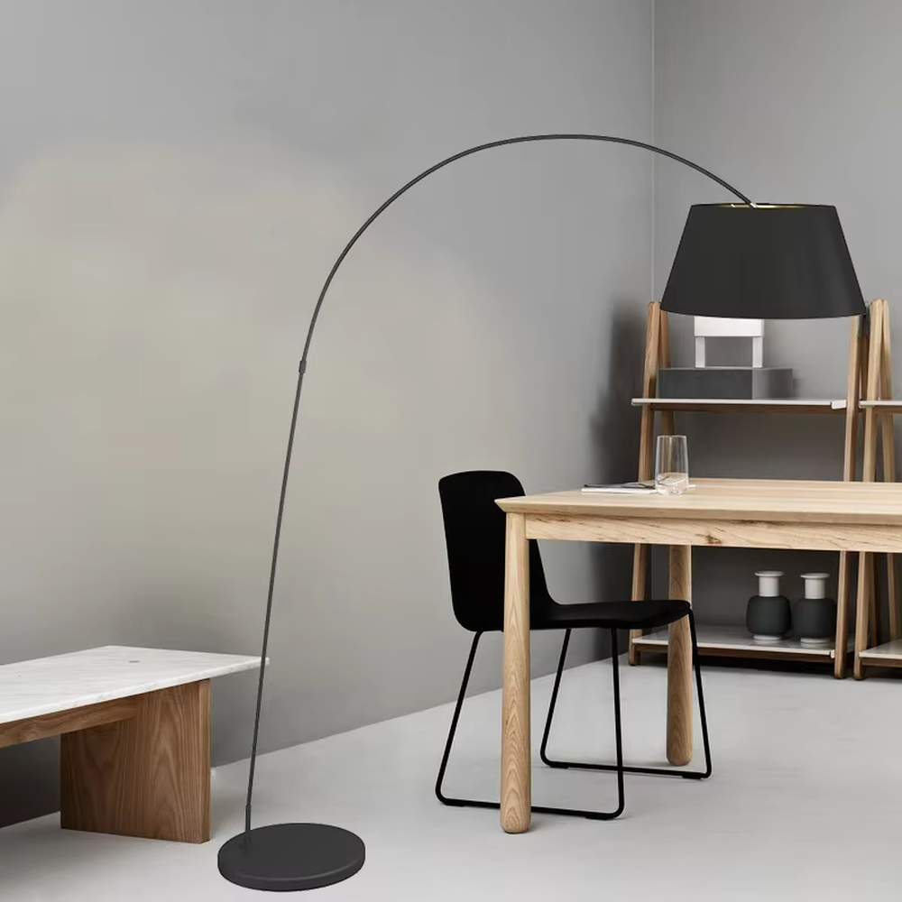 Modern minimalist curved floor lamp, black curved lamp pole paired with a black-outside-gold-inside hemisphere lampshade and a black disc base, soft and warm lighting, creating a minimalist high-end space atmosphere.