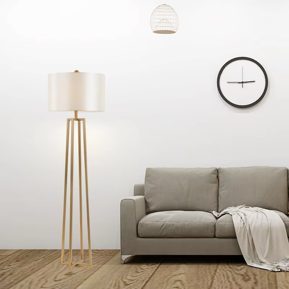 This is a light luxury minimalist golden geometric frame floor lamp, featuring a golden triangular geometric frame lamp pole paired with a white cylindrical fabric lampshade. It has a minimalist and grand design, with soft and uniform lighting. It is used for space lighting and decoration, creating a light luxury minimalist atmosphere. Suitable for light luxury-style living rooms, modern minimalist bedrooms, high-end apartments and other places.