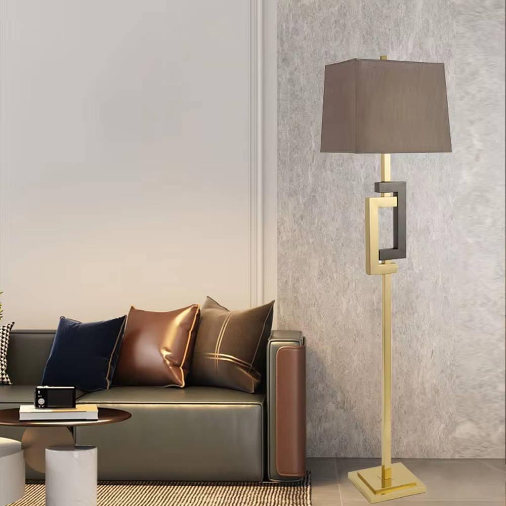 Light luxury black-gold geometric decorative floor lamp, golden metal lamp pole + dark brown square fabric lampshade, soft lighting, creating a high-end elegant atmosphere.