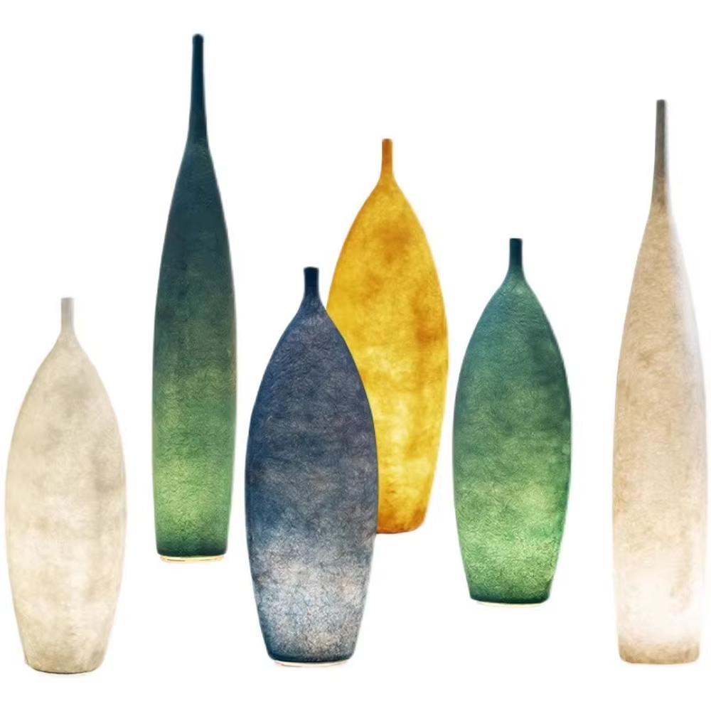 This is a Zen minimalist bottle-shaped paper art floor lamp (including large and small styles), made of light beige paper art texture material to create a slender bottle shape, with a large and small combination design. The light through the material is soft and hazy, creating a quiet and elegant atmosphere. It is used for space lighting and decoration, suitable for Zen-style spaces, minimalist homes and other places.