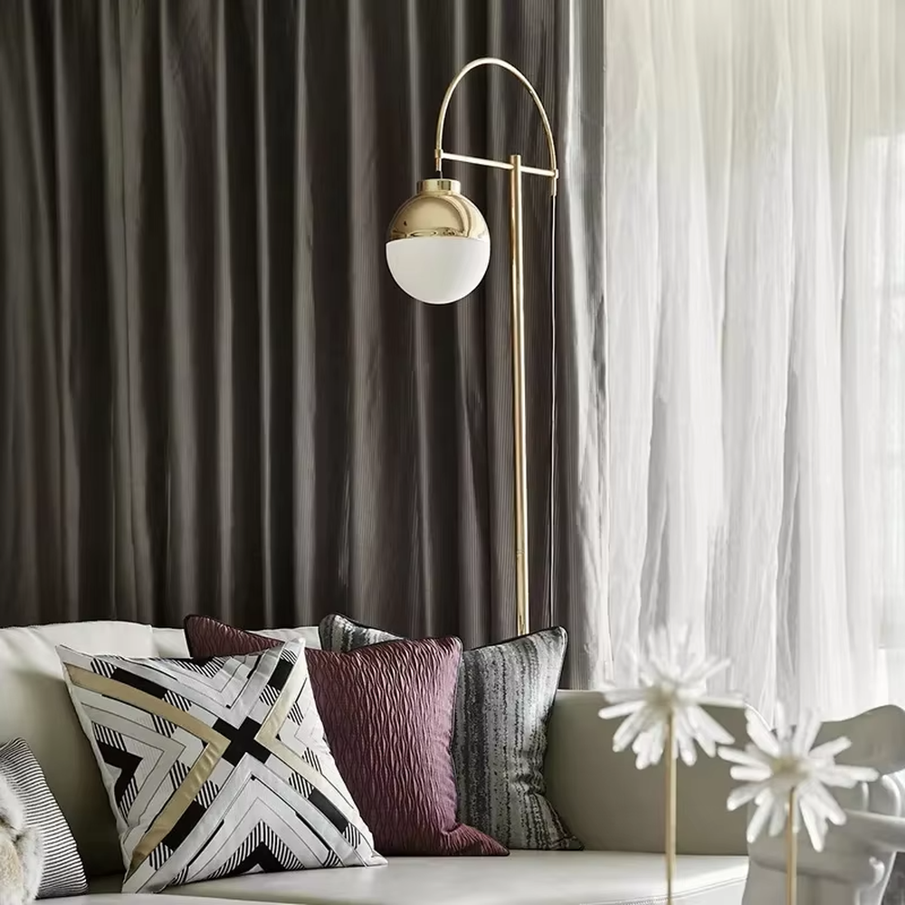 Light luxury golden curved metal floor lamp, spherical gold-frame white shade + round base, soft lighting, creating a high-end elegant atmosphere.