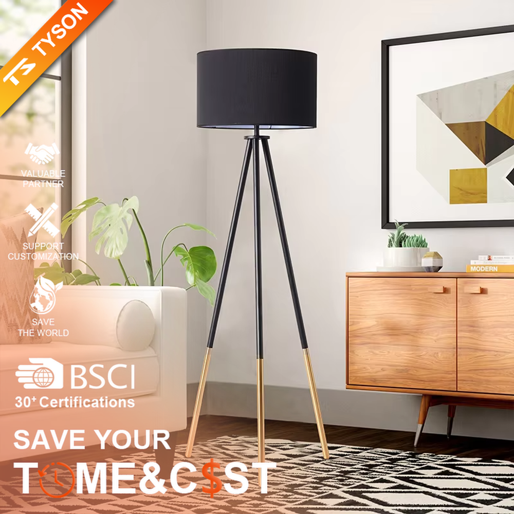 Light luxury black-gold spliced tripod floor lamp, brown fabric cylindrical lampshade + black pole gold foot stand, soft lighting, creating a high-end minimalist atmosphere.
