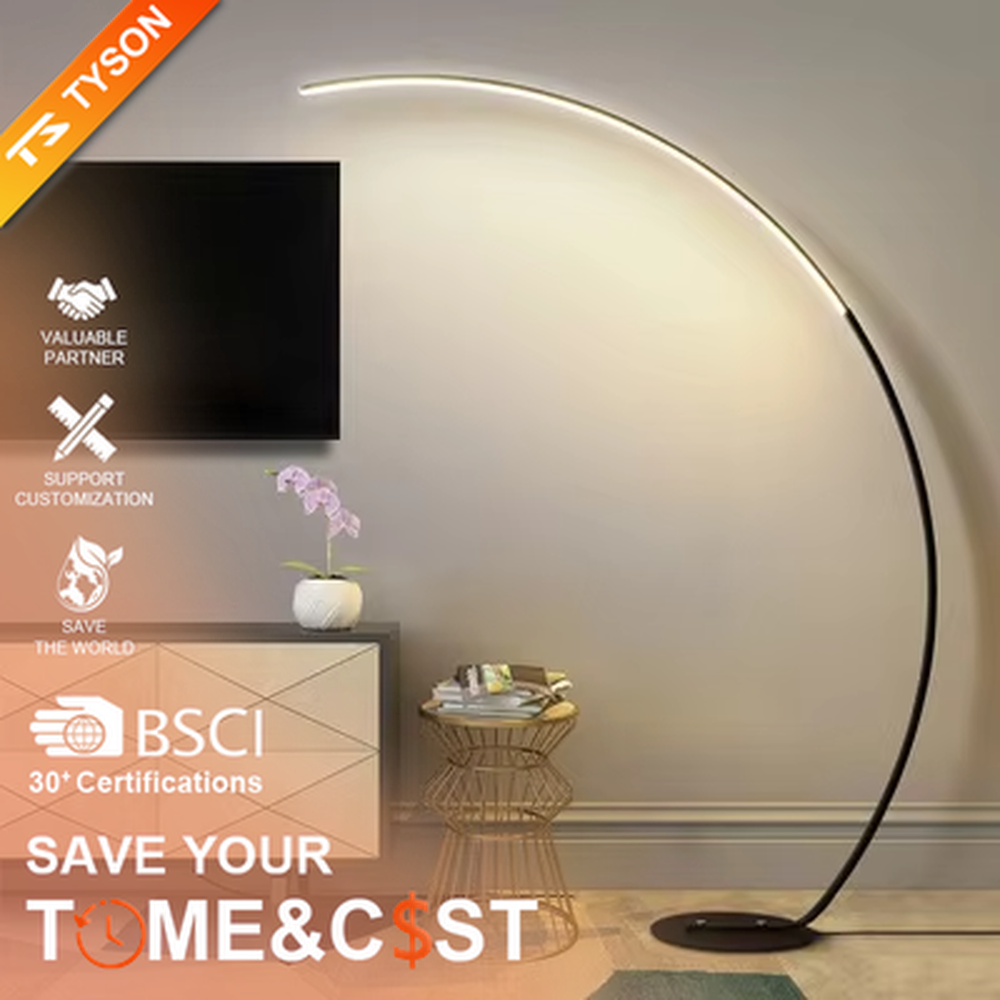 Modern minimalist black metal curved strip LED floor lamp, black metal curved stand + strip LED lamp body + soft warm light, creating a simple high-end home atmosphere.