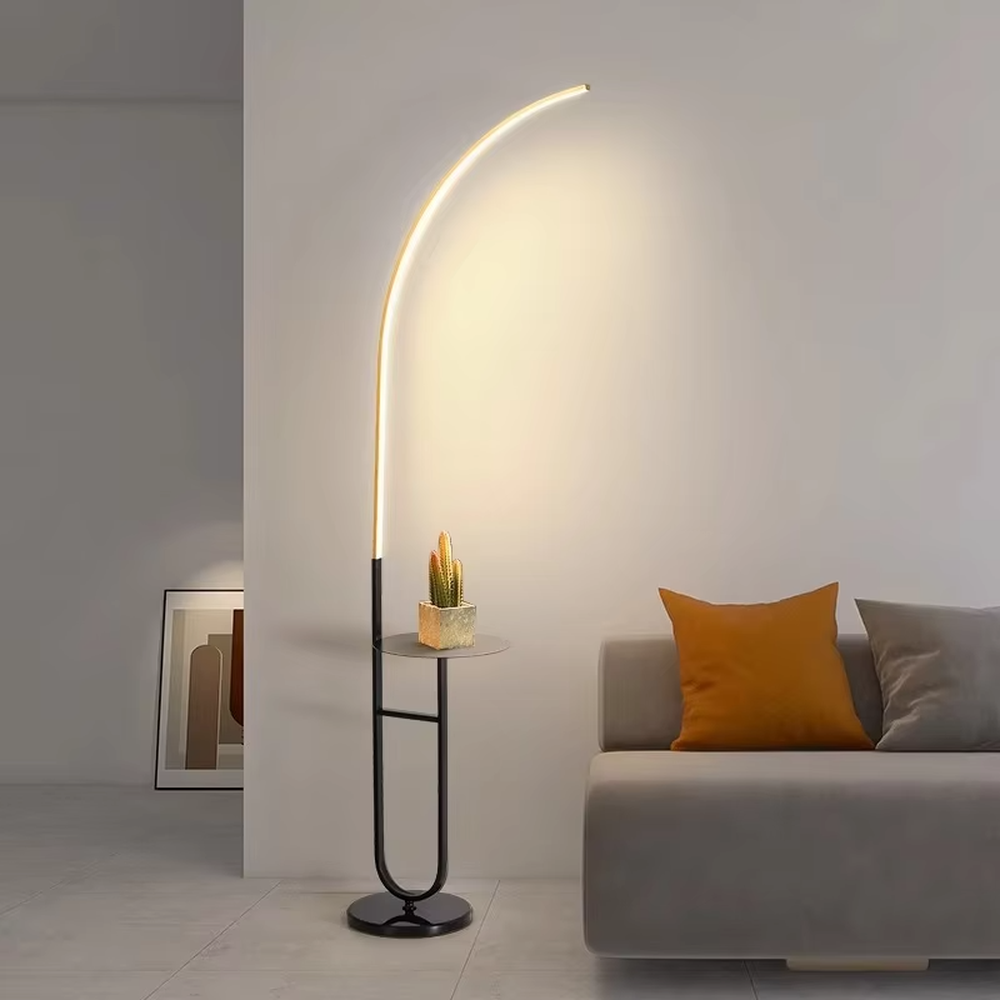 Modern minimalist black metal curved LED floor lamp (with round small side table), soft and uniform warm light, creating a simple practical home atmosphere.