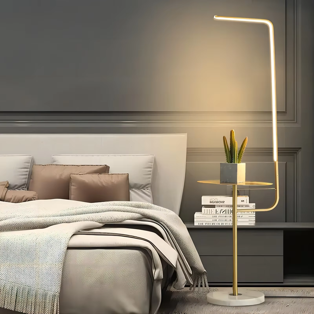 Light luxury golden L-shaped LED strip floor lamp with side table, gold metal stand + round small side table + white marble base, soft warm light, creating a high-end practical light luxury atmosphere.
