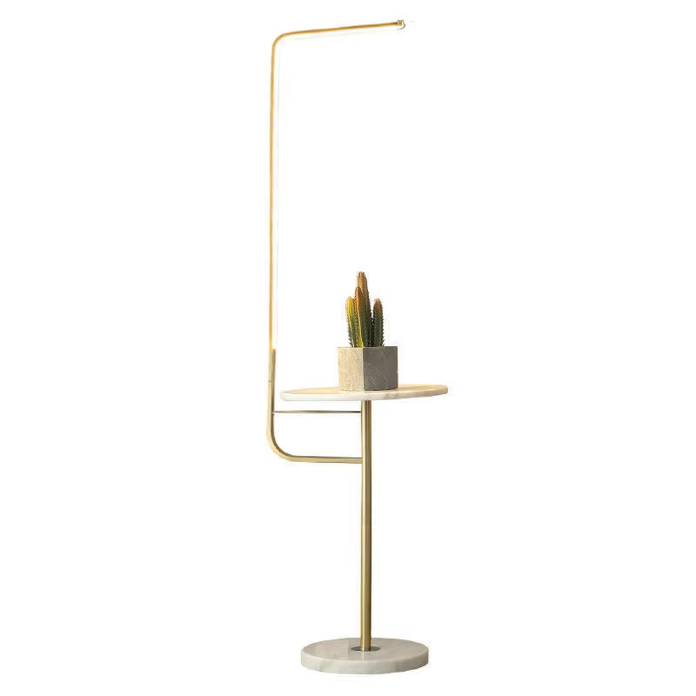 Light luxury golden L-shaped LED strip floor lamp with transparent side table, golden metal L-shaped stand + transparent round side table + white marble base, soft warm light, creating a high-end practical light luxury atmosphere.