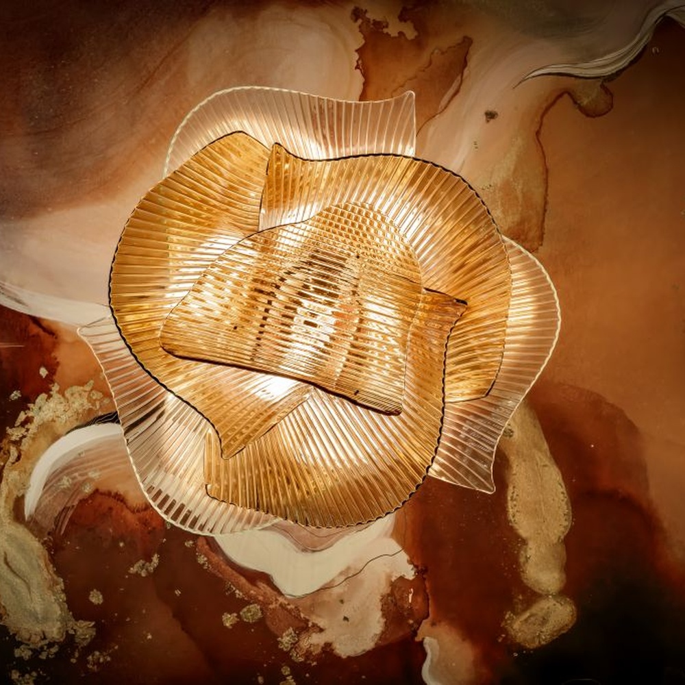 This modern light luxury art chandelier is made of metal mesh/acrylic material with a layered streamlined shape, hanging down like flowing fabric. Warm light passes through the material to emit a soft and transparent halo, serving both lighting and decorative purposes, suitable for high-end commercial spaces such as luxury restaurants and clubs.