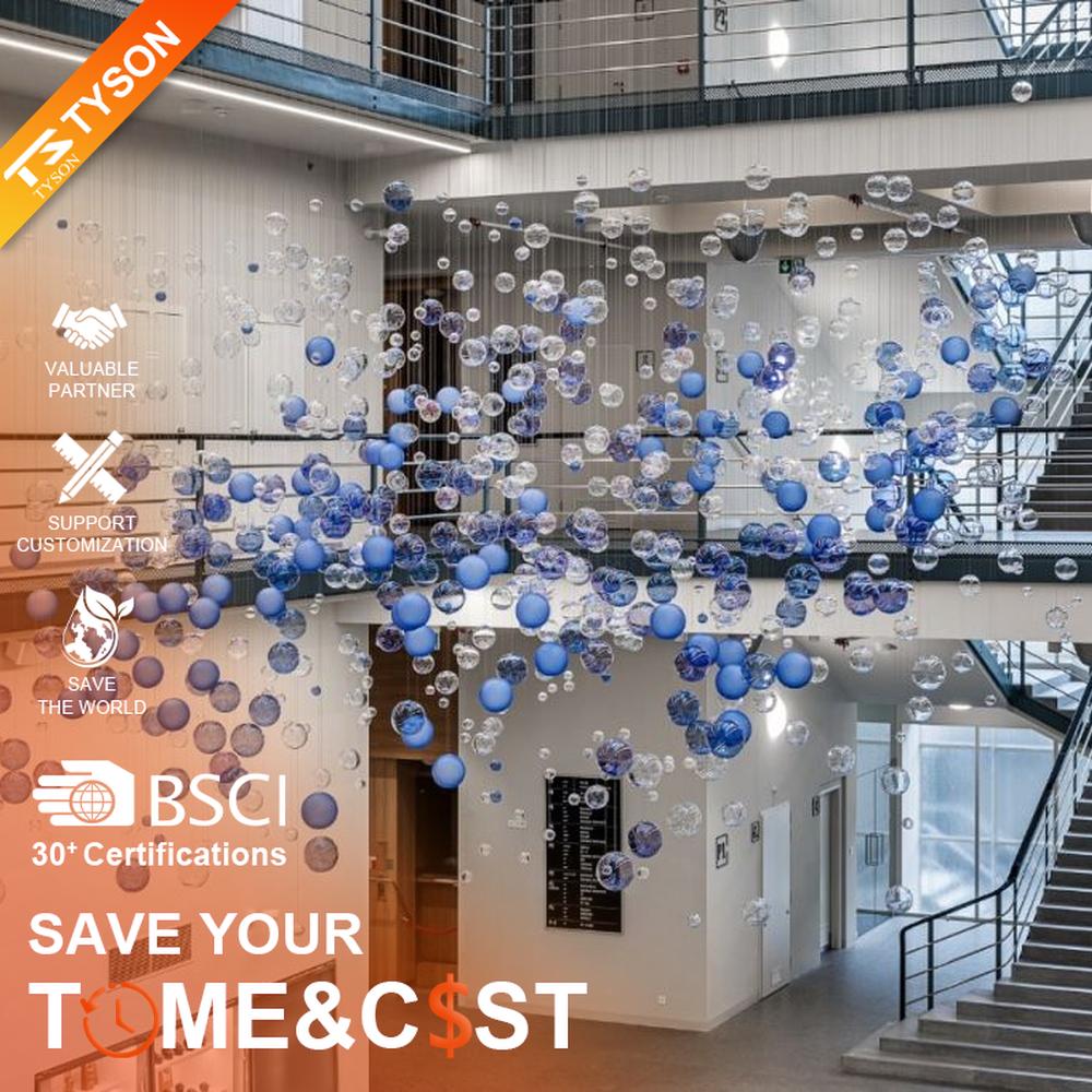 This is a modern art-style suspended bubble installation lamp, composed of transparent and blue-purple gradient spherical elements hung in a staggered manner, with both decorative and lighting functions, ideal for multi-story high-ceiling public spaces such as shopping mall atriums and office building lobbies.