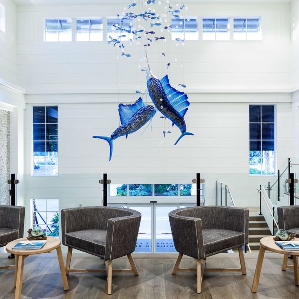 This ocean-themed art chandelier features swordfish shapes made of blue liuli, paired with bubble decorations, presenting a dynamic deep-sea swimming effect, serving both lighting and decorative purposes, suitable for coastal hotels, seafood restaurants and other spaces.