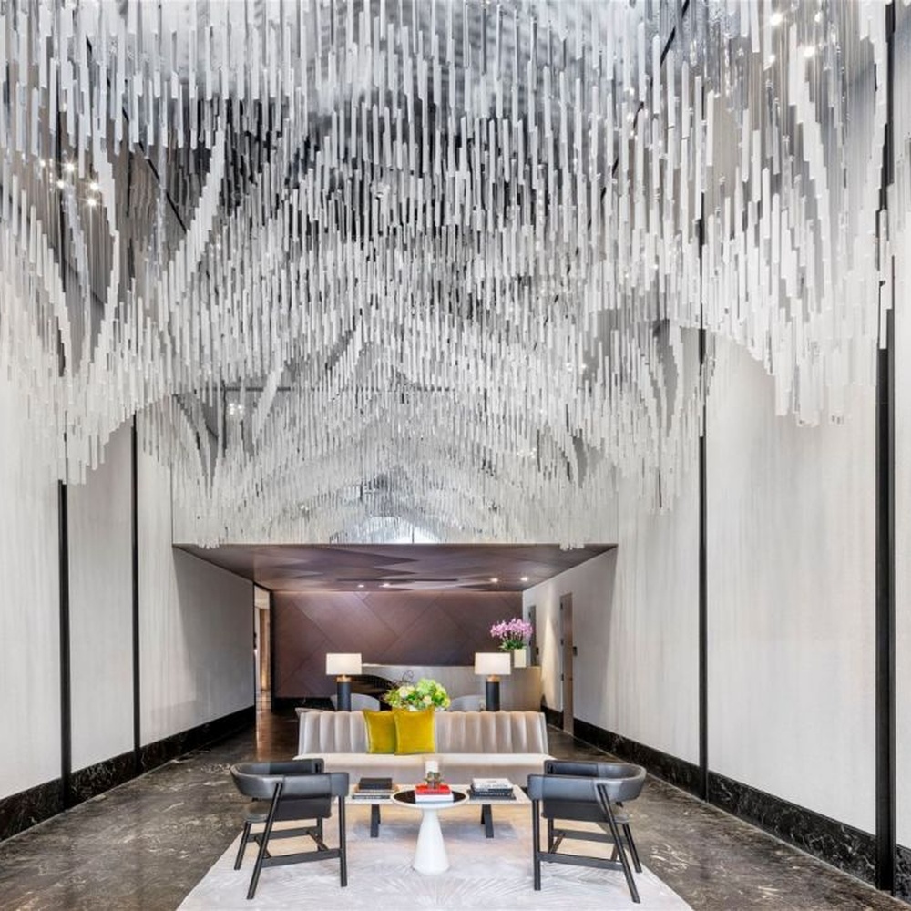 Modern Art Rain Curtain Crystal Chandelier, composed of numerous transparent crystal/acrylic strips suspended in a staggered arrangement, serves both lighting and decorative purposes, ideal for hotel lobbies, sales centers, high-end clubs and other high-ceiling public spaces.