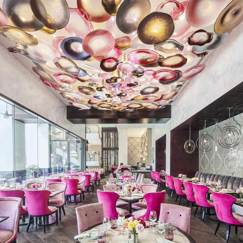 This iridescent bubble art ceiling lamp is composed of a large number of gradient-colored glass discs in pink-gold, purple-brown, etc., arranged staggered to cover the ceiling like flowing colorful light spots. Light refracts through the glass to emit a soft and transparent halo, serving both lighting and decorative purposes, suitable for trendy commercial spaces such as internet-famous restaurants and art bars.