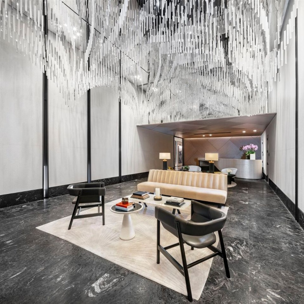 Modern Art Rain Curtain Crystal Chandelier, composed of numerous transparent crystal/acrylic strips suspended in a staggered arrangement, serves both lighting and decorative purposes, ideal for hotel lobbies, sales centers, high-end clubs and other high-ceiling public spaces.