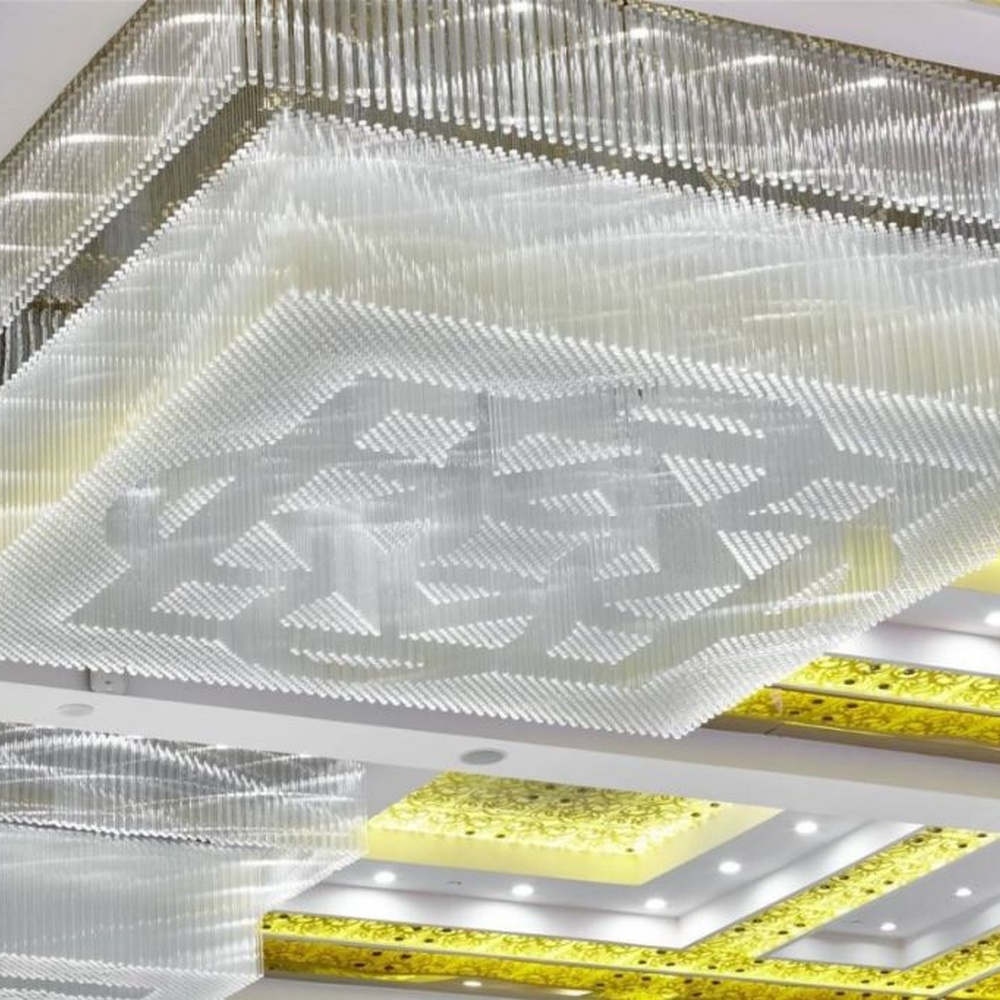 This large-scale engineering crystal ceiling lamp consists of a large number of transparent crystal strips arranged vertically, creating a geometric texture visual effect. Light refracts through the crystals to emit a brilliant and soft halo, serving both lighting and decorative purposes, suitable for high-end large commercial spaces such as hotel lobbies and banquet halls.