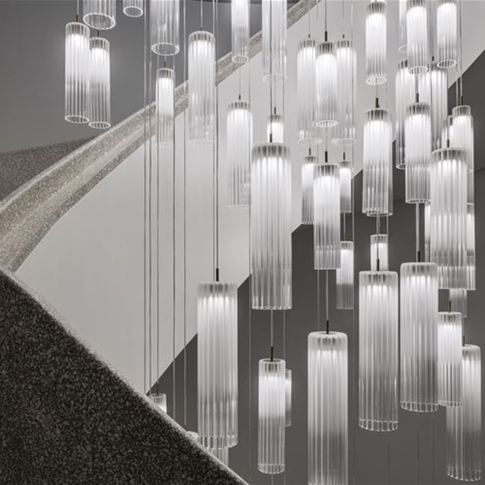 This is a modern minimalist large waterfall-style pendant chandelier, composed of densely hung transparent and translucent crystal tubes, presenting a dynamic flowing water shape, with both decorative and lighting functions, ideal for high-ceiling public spaces such as hotel lobbies and shopping mall atriums.