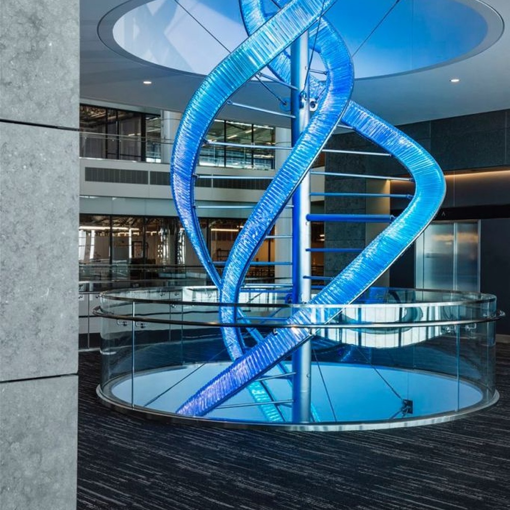 This is a large suspended art installation lamp, supported by a metal frame with blue-purple-cyan gradient LED light strips, featuring an abstract spiral and crescent shape, with both decorative and lighting functions, ideal as artistic decorative lighting for public spaces.