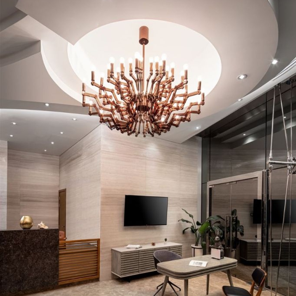 This branch-shaped multi-head chandelier features a fork-shaped lamp frame made of wood-like material, paired with multiple groups of staggered light-emitting lamp heads, presenting a visual effect that combines natural artistry and modern industrial style, suitable for core lighting and decoration in high-ceiling public spaces.