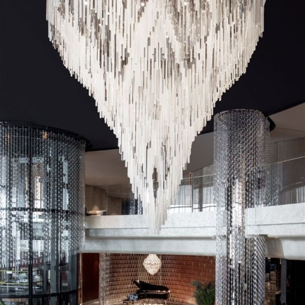 Modern Art Waterdrop Rain Curtain Crystal Chandelier, composed of numerous white transparent crystal/acrylic strips suspended in an irregular waterdrop shape, serves both lighting and decorative purposes, ideal for luxury hotel lobbies, sales centers, high-end clubs, art galleries and other high-ceiling public spaces.