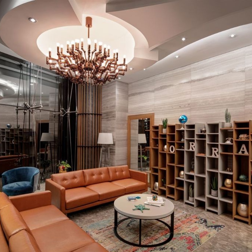 This branch-shaped multi-head chandelier features a fork-shaped lamp frame made of wood-like material, paired with multiple groups of staggered light-emitting lamp heads, presenting a visual effect that combines natural artistry and modern industrial style, suitable for core lighting and decoration in high-ceiling public spaces.