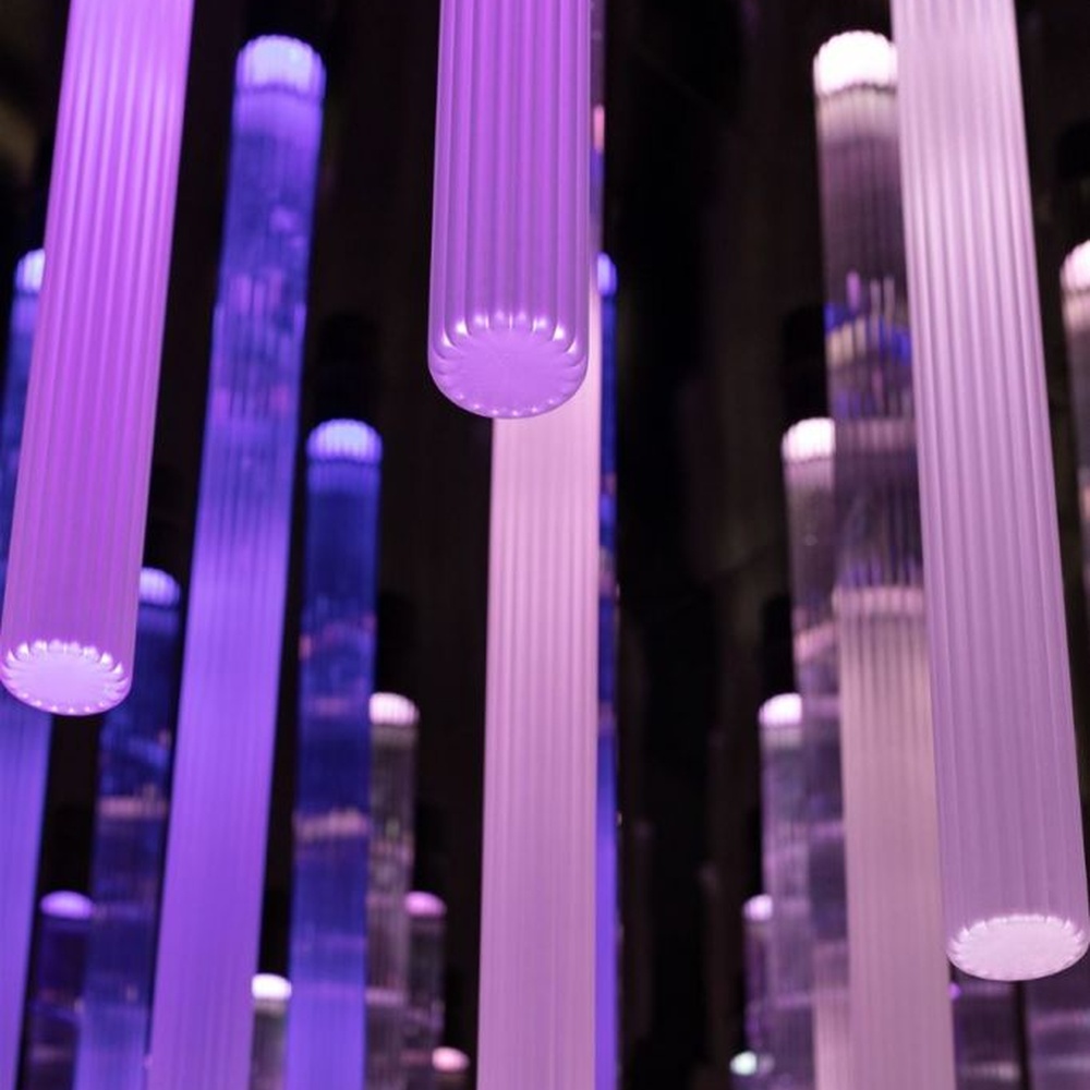 This is an immersive LED pendant light array, composed of densely arranged purple gradient LED light strips arranged vertically, presenting a flowing starry sky effect, with both decorative and atmosphere-creating functions, ideal for trendy commercial spaces such as brand stores and commercial entrances.
