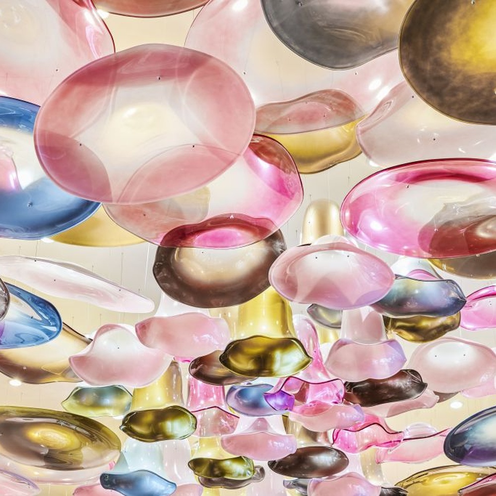 This iridescent bubble art ceiling lamp is composed of a large number of gradient-colored glass discs in pink-gold, purple-brown, etc., arranged staggered to cover the ceiling like flowing colorful light spots. Light refracts through the glass to emit a soft and transparent halo, serving both lighting and decorative purposes, suitable for trendy commercial spaces such as internet-famous restaurants and art bars.